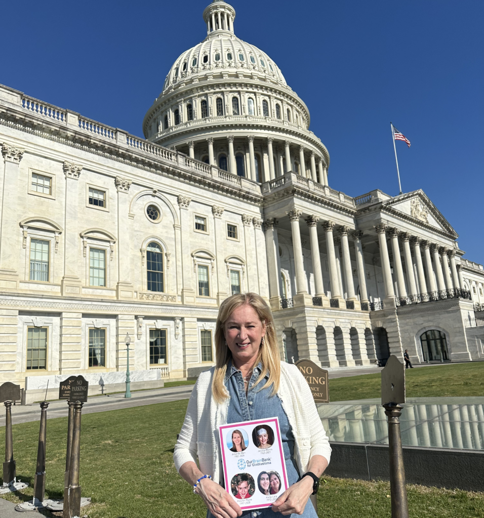 OurBrainBank for Glioblastoma. Executive Director Kelli Duprey in Washington DC for Head to the Hill, 2026. Poster with photos of people lost to GBM.